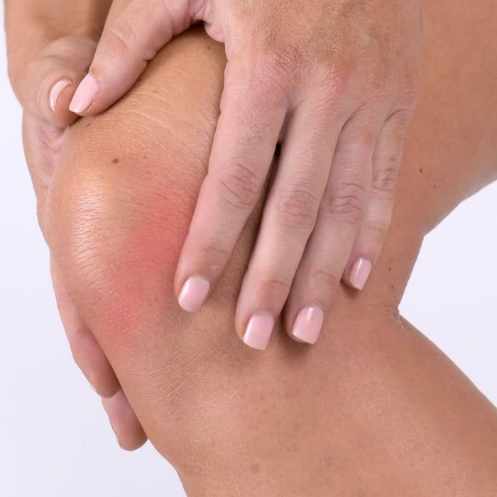 Hands on sore knee