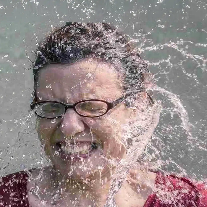 Water splashing in woman's face