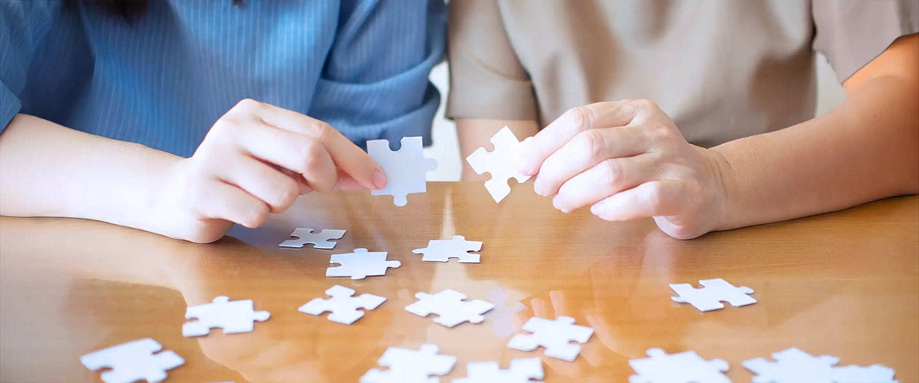 Elderly and young female playing jigsaw puzzle