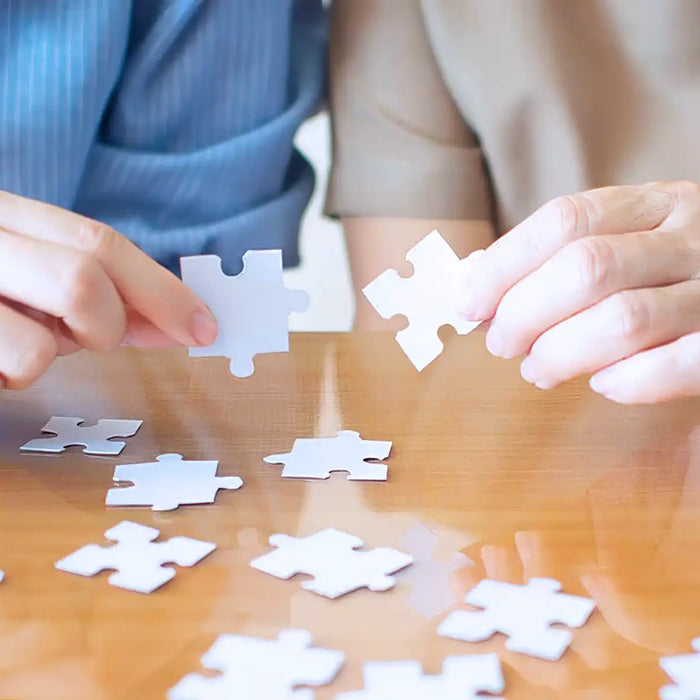 Elderly and young female playing jigsaw puzzle