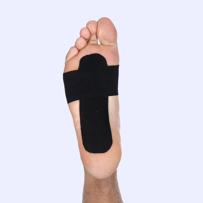 Foot with black tape on sole