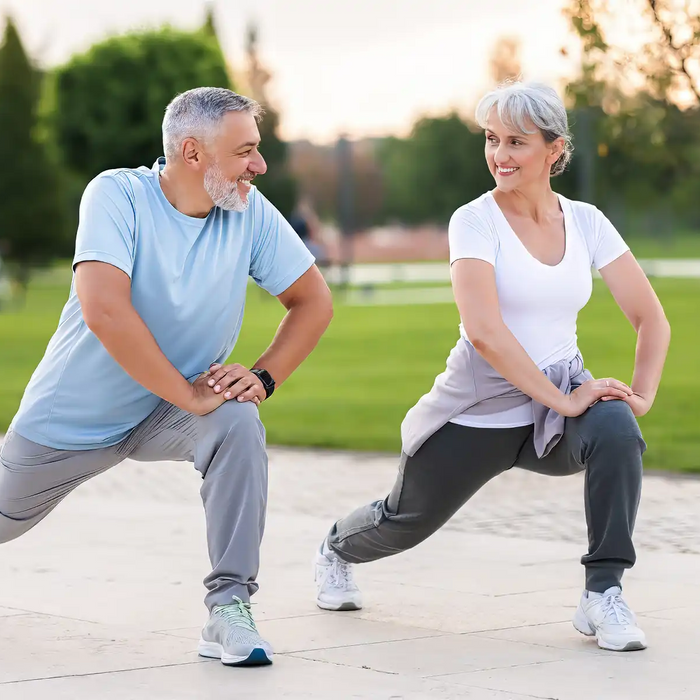 Joyful senior husband and wife making sport outdoors