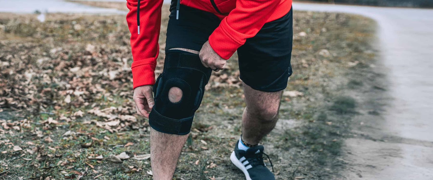 Man holding knee brace