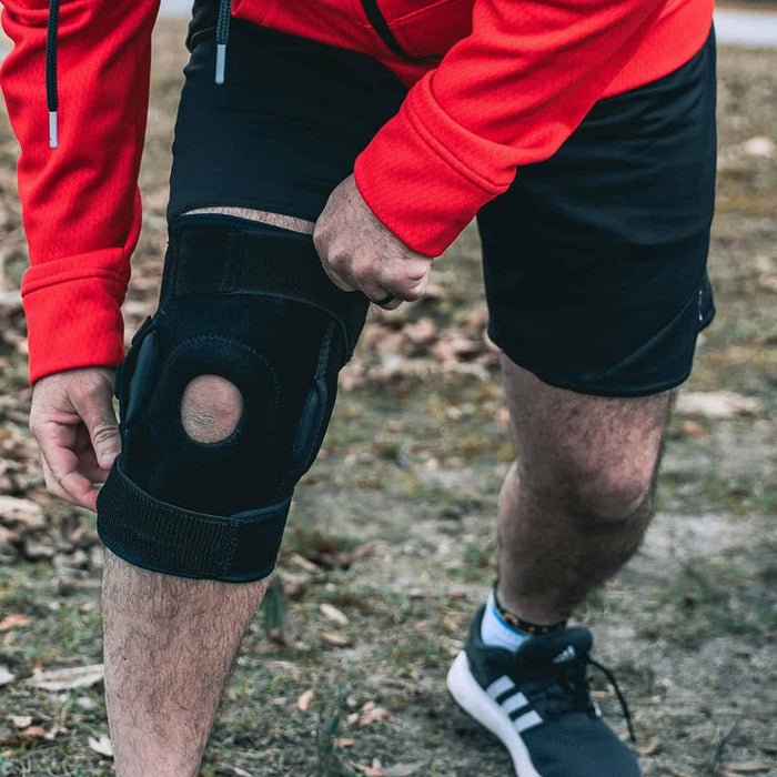 Man holding knee brace