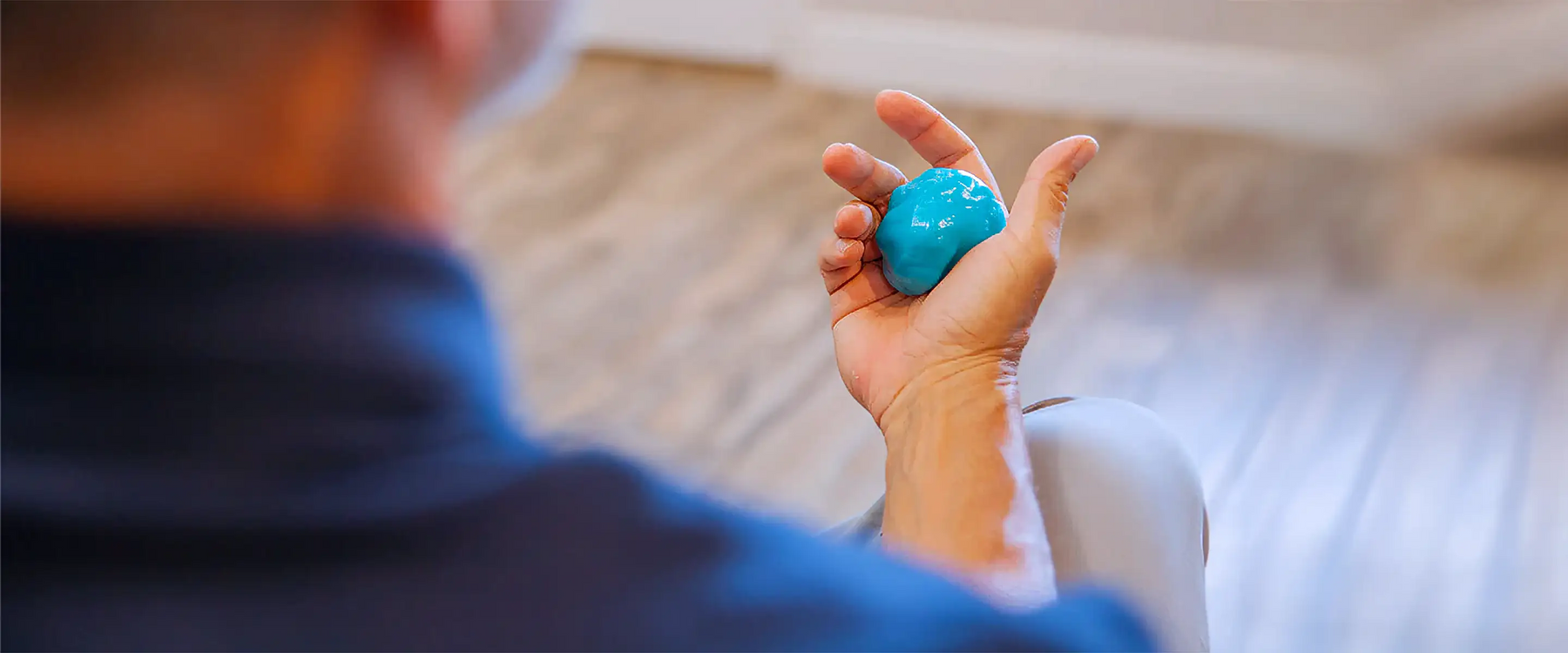 Man holding therapy putty