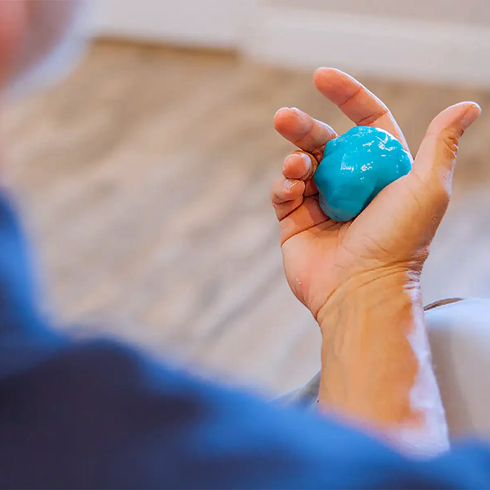 Man holding therapy putty