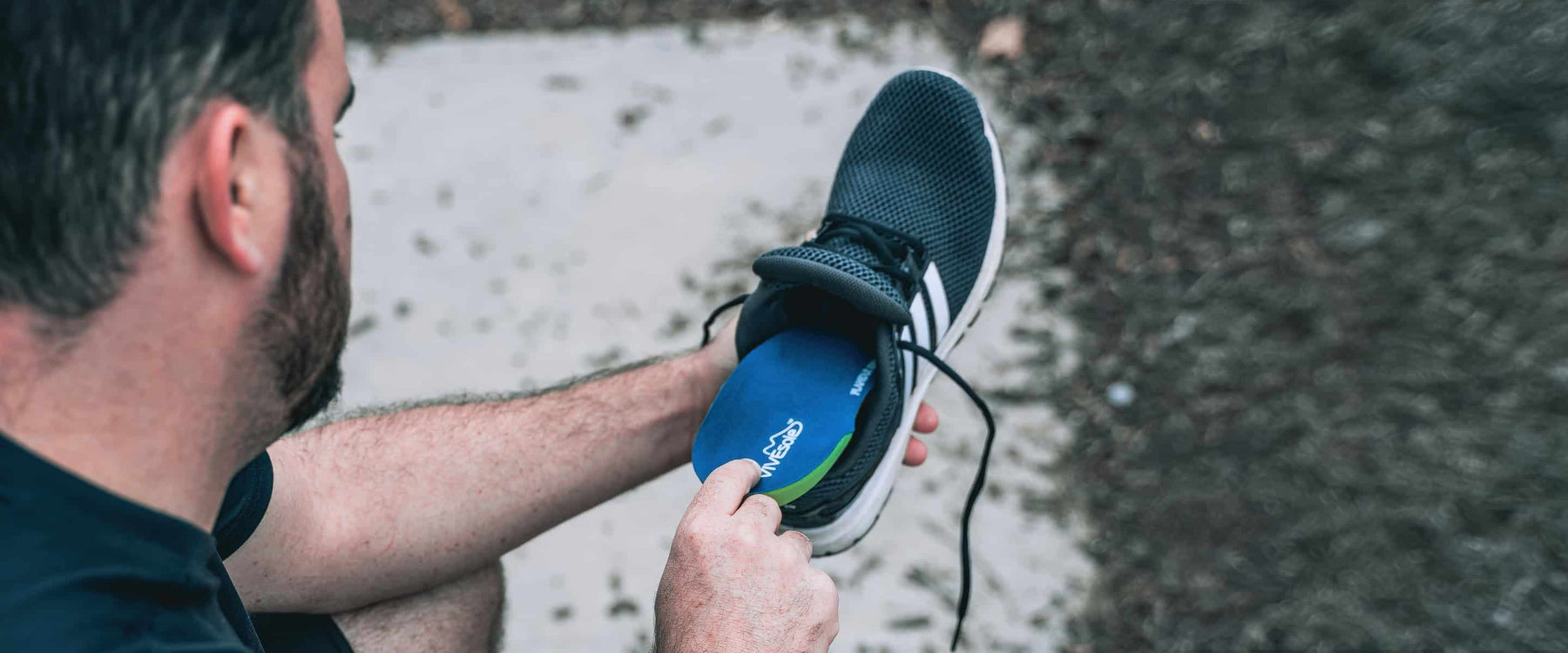 Man inserting shoe insole