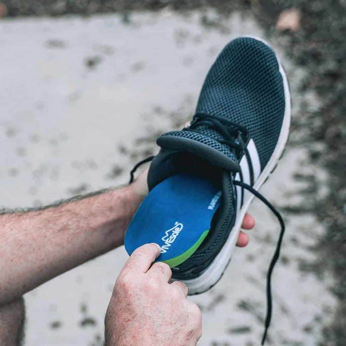 Man inserting shoe insole