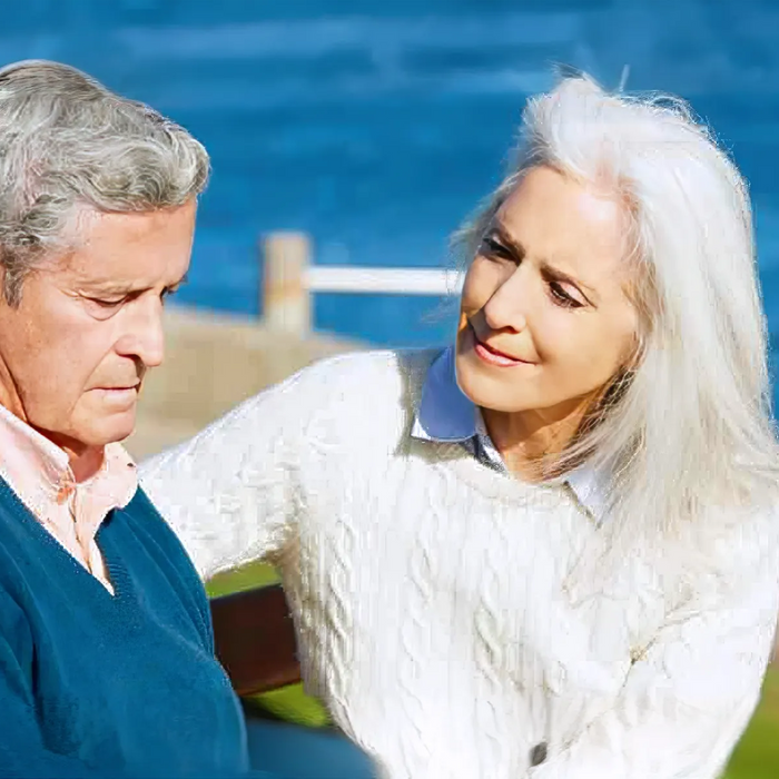 Senior-Woman Comforting Depressed Husband Sitting On Bench