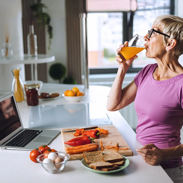 Senior woman drinking juice