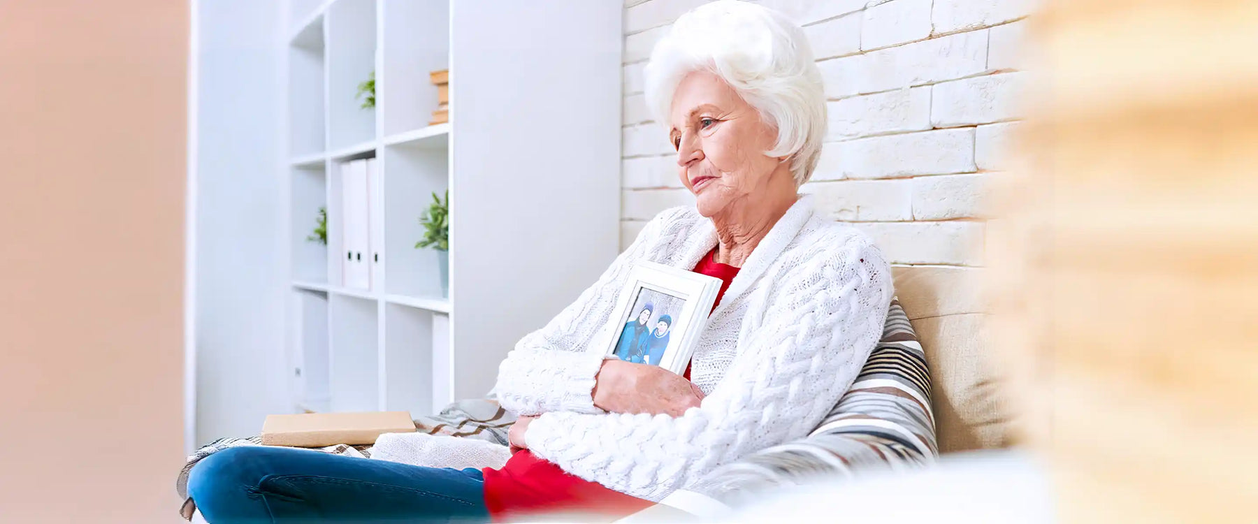 Senior woman sitting at home alone in armchair