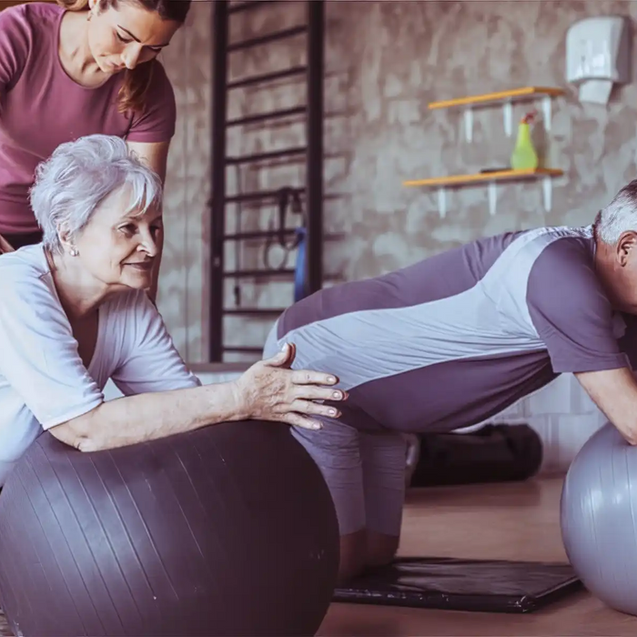 Senior people on pilates ball