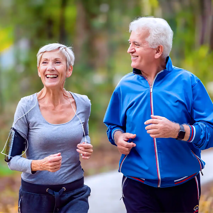 Smiling senior couple jogging in the park