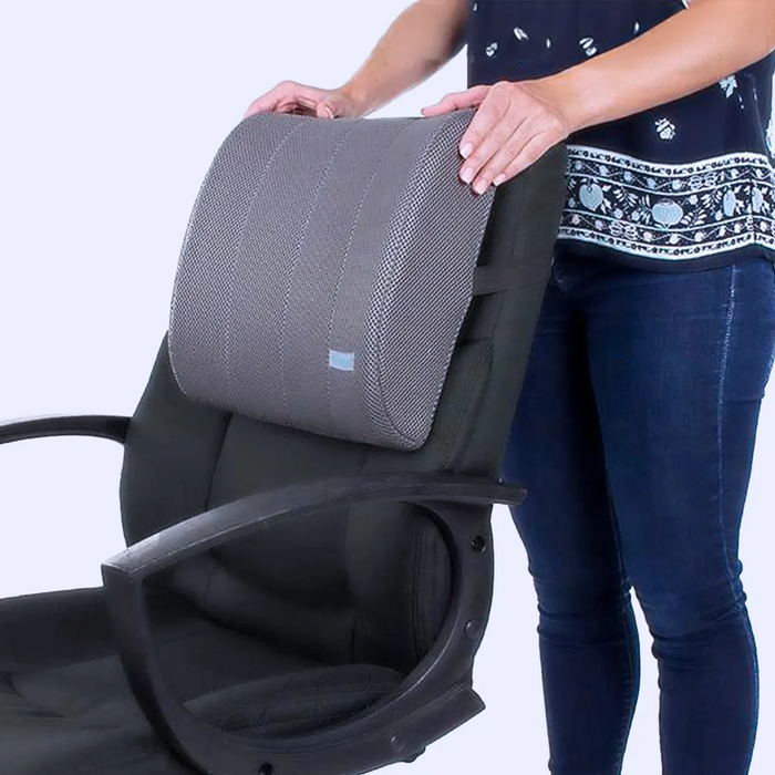 Woman holding a lumbar cushion on the chair