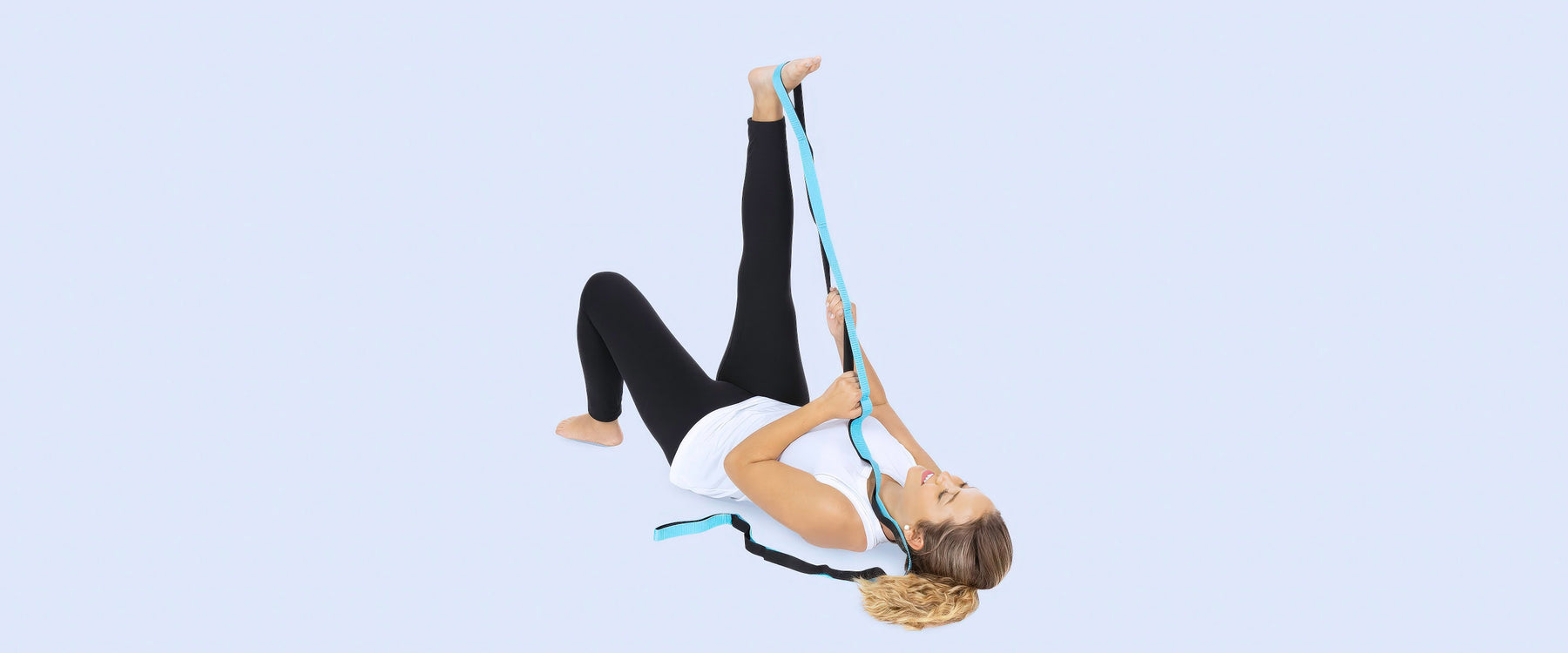 Woman stretching her leg with stretch strap