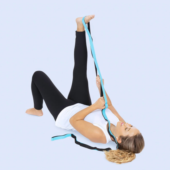 Woman stretching her leg with stretch strap