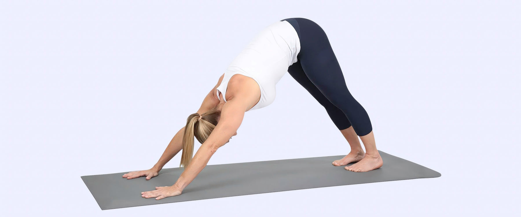 Woman performing a pose on a yoga mat