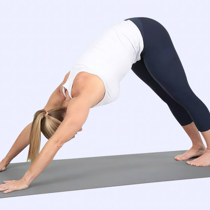 Woman performing a pose on a yoga mat