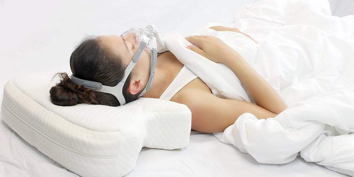 Woman sleeping with CPAP Mask