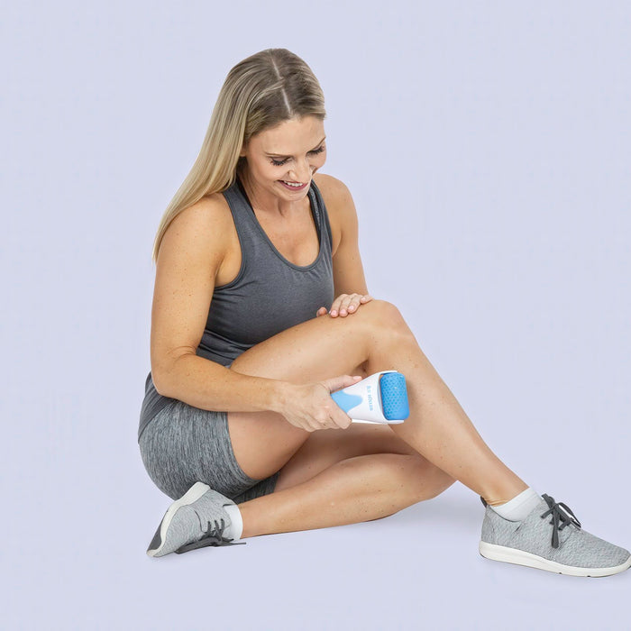 Woman using cold roller on shin