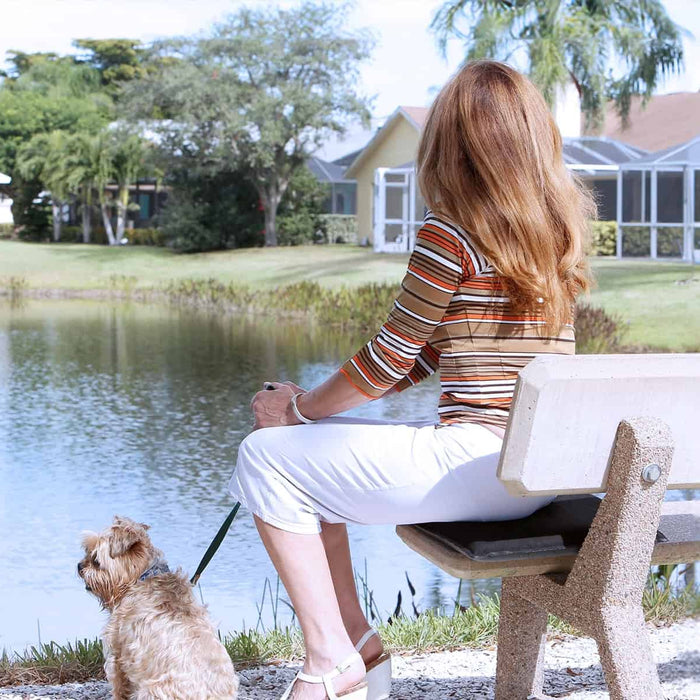 Woman sitting near a pond