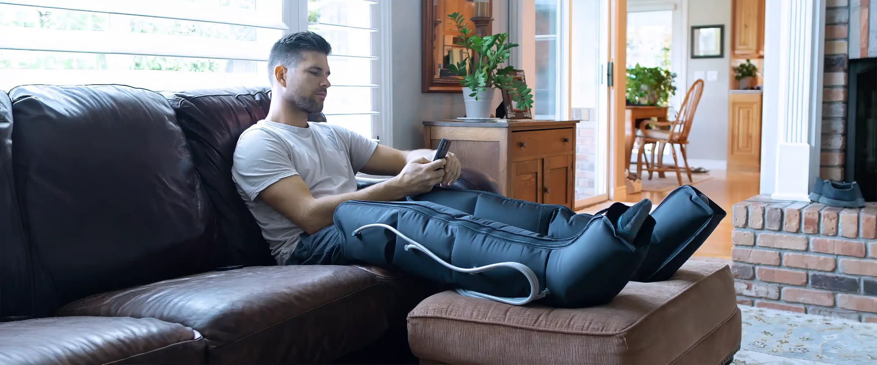 man using leg compression device