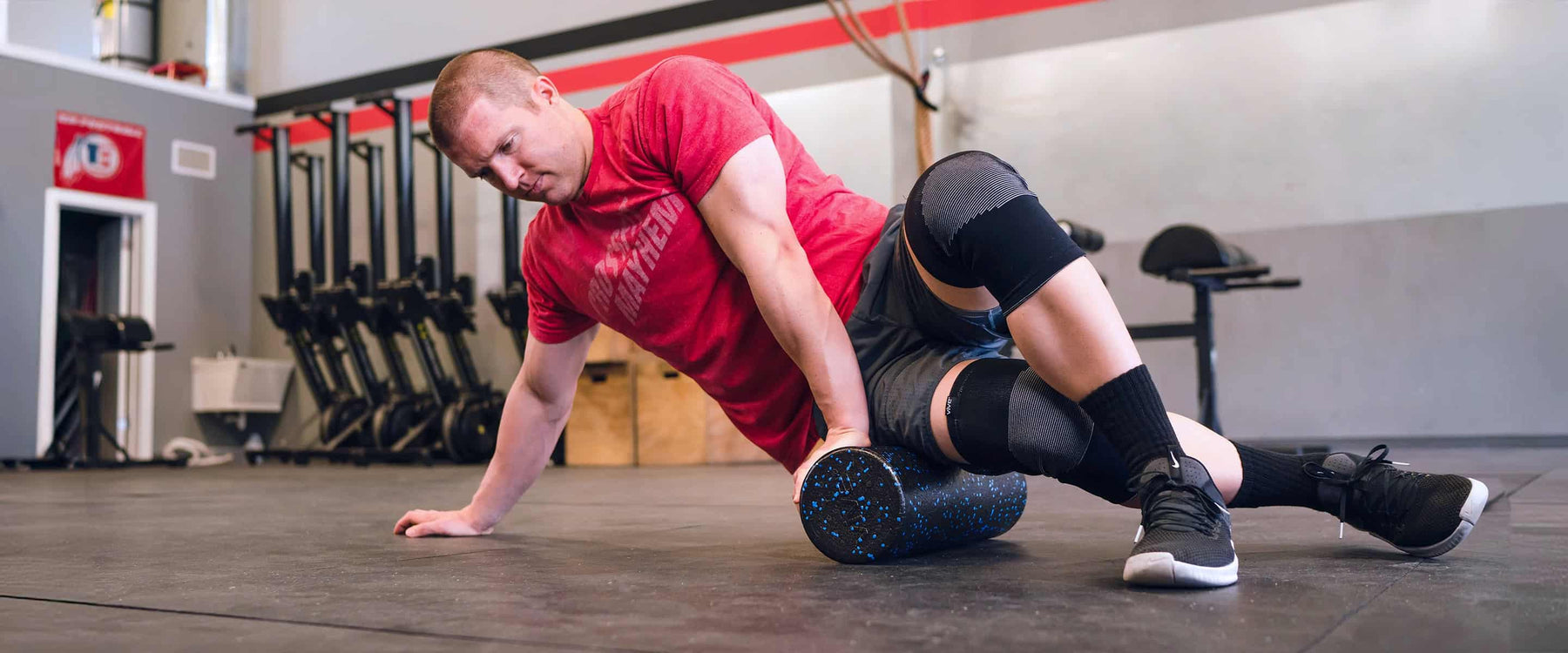 man using foam roller