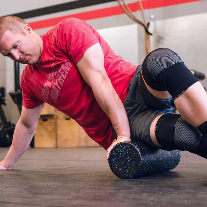 man using foam roller