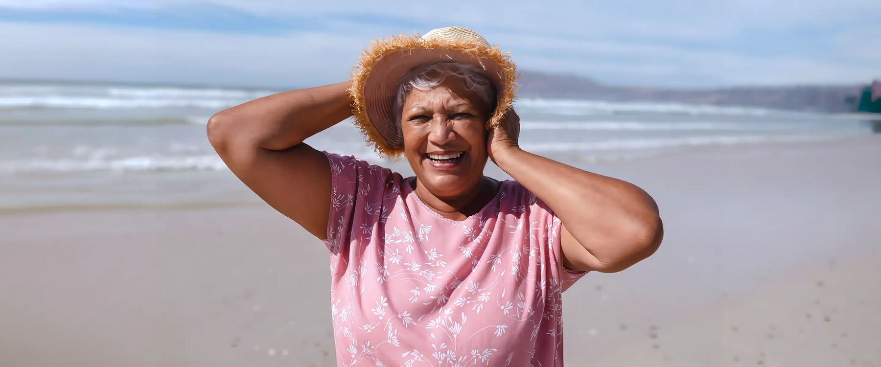 elderly woman on beach in sun