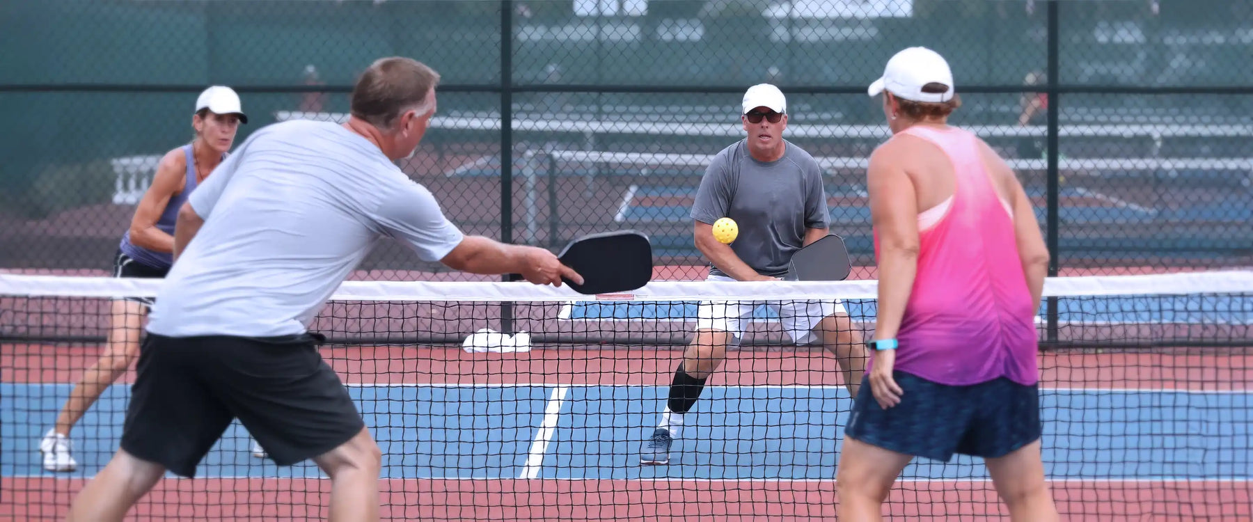 senior playing pickleball tournament